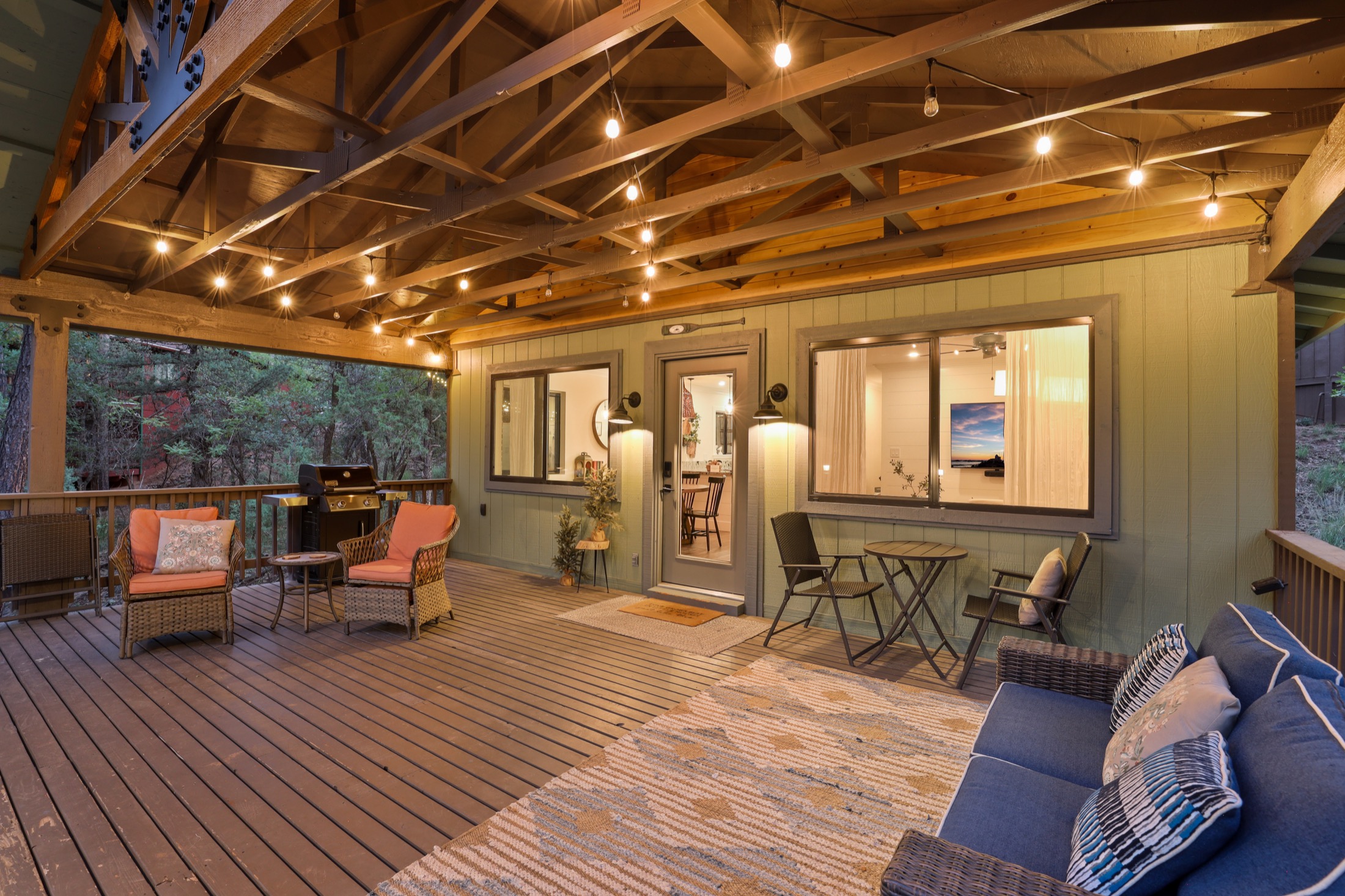 Evening deck seating beneath string lights