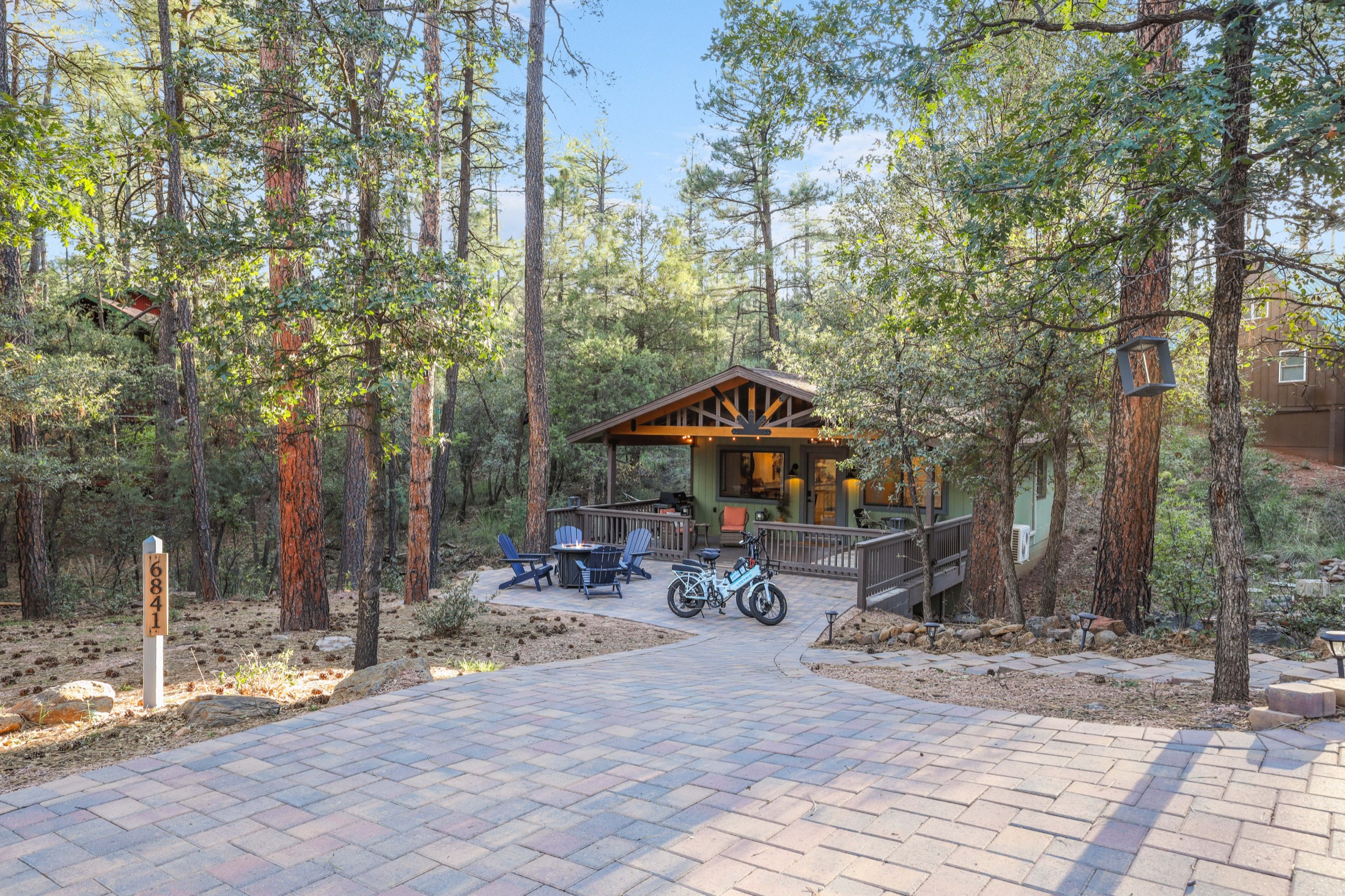 Daylight exterior of Serenity Pines Hideaway surrounded by tall pines
