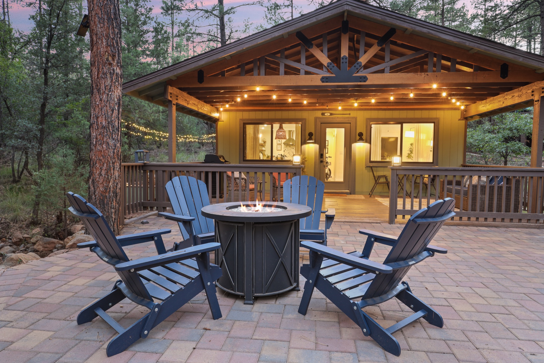 Fire pit and chairs outside Serenity Pines Hideaway at dusk